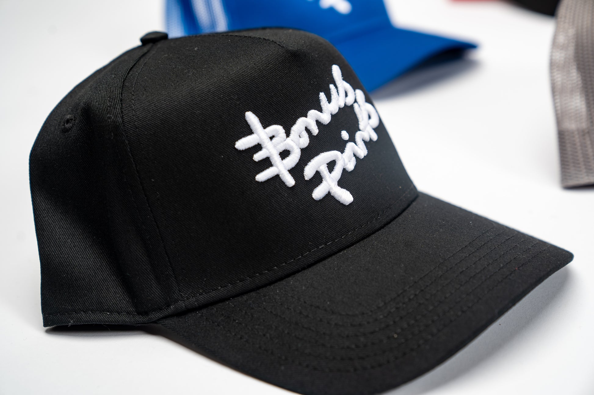 Close up Side View  of Black “Extra Credit”  SnapBack Hat.