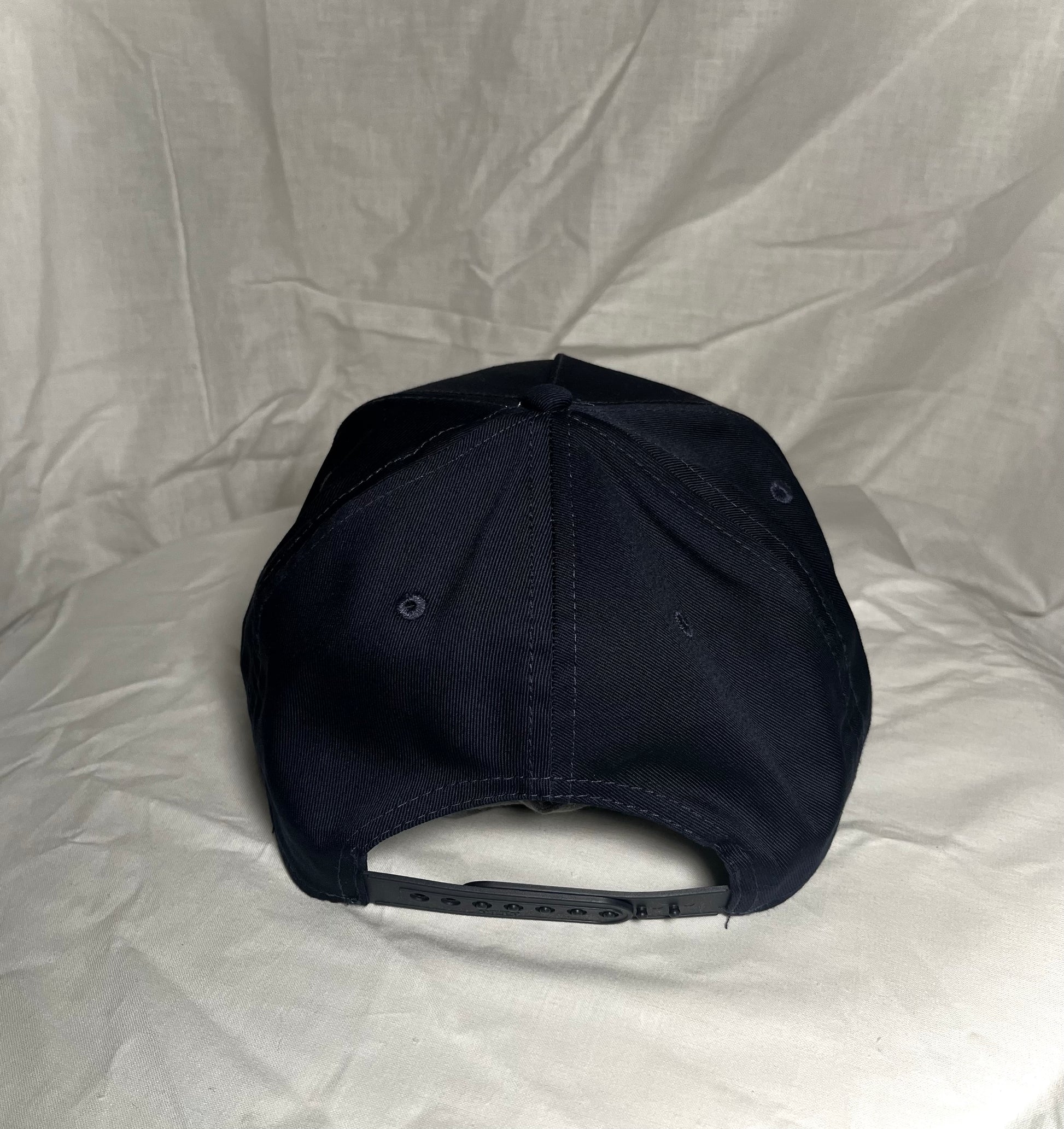 Back view of Navy Blue SnapBack With White Extra Credit Logo puff embroidered across front panel